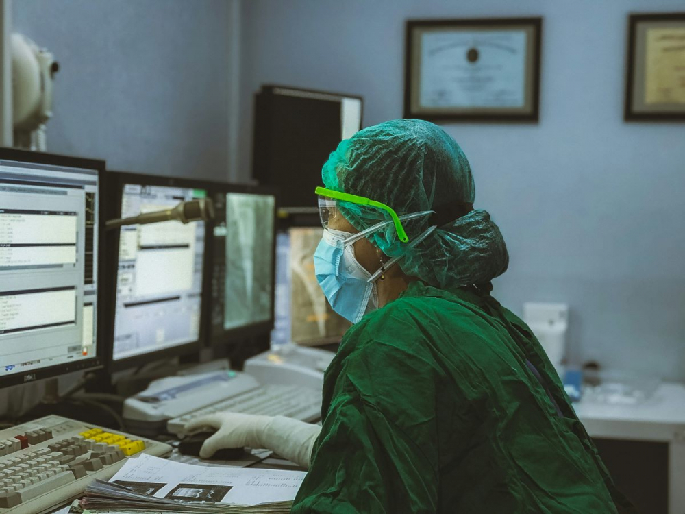 Healthcare worker looking at computer screens